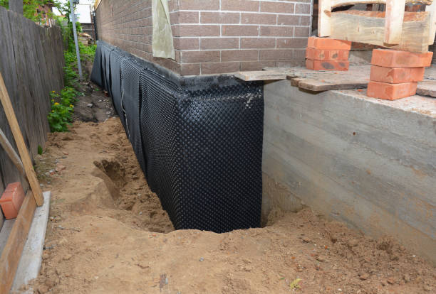 SJ Waterproofing Pros technician performing targeted Exterior Waterproofing assessment in Menominee, MI